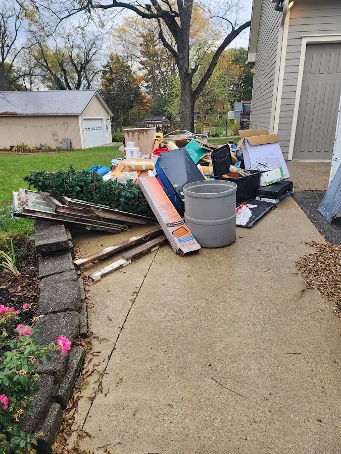 Dumpster being loaded with debris for Estate Cleanout Dumpster Rental in Hamilton